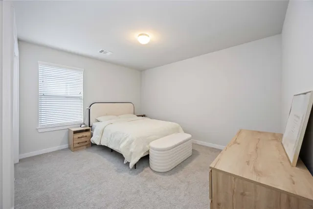 a bedroom with a bed and window