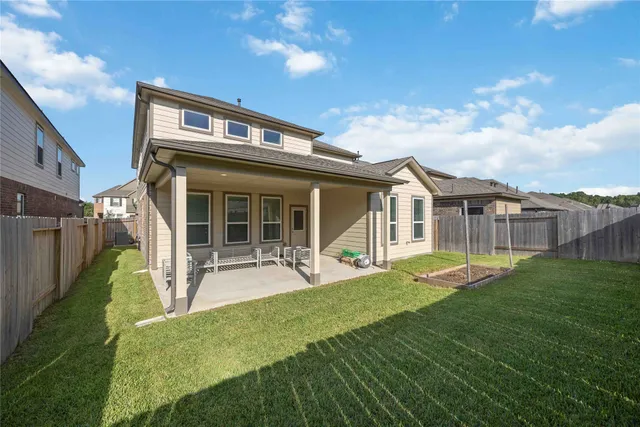a house view with a sitting space and garden space