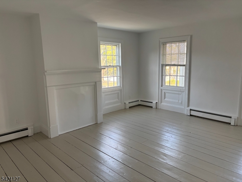 43 Old Turnpike Road Oldwick, NJ 08858 - Photo 7 of 18 an empty room with wooden floor and windows
