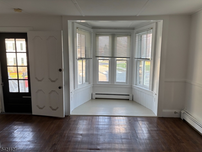 43 Old Turnpike Road Oldwick, NJ 08858 - Photo 8 of 18 an empty room with wooden floor and windows