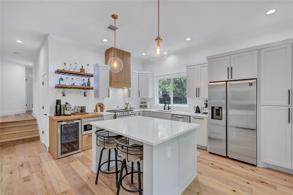 3600 Rip Ford Drive Austin, TX 78732 - Photo 14 of 32 a kitchen with a center island a counter space stainless steel appliances and wooden floor