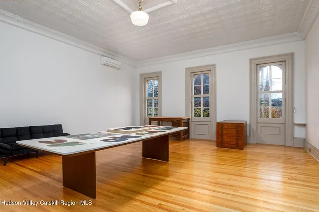 a room with wooden floor and furniture