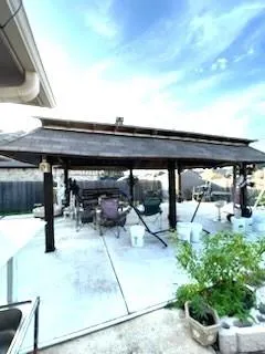 a roof deck with table and chairs a barbeque