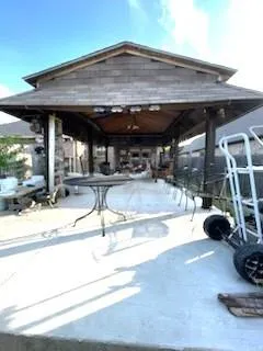 a view of a patio with a table and chairs