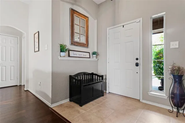 an entryway with a window and wooden floor