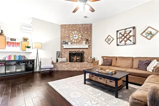 a living room with furniture a fireplace and a flat screen tv