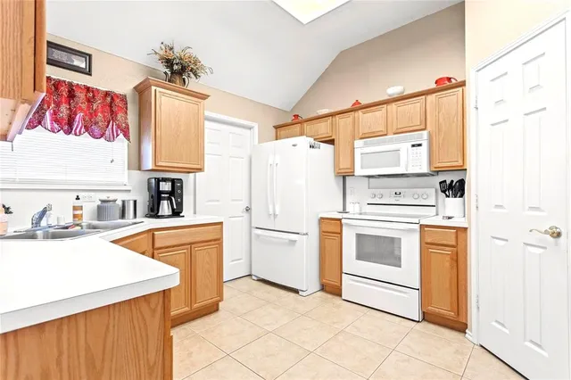 a kitchen with stainless steel appliances a stove a sink and a refrigerator