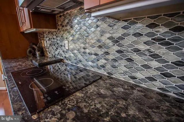 a kitchen with granite countertop a sink and a counter top space