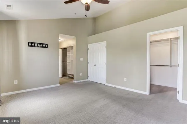 a view of an empty room with a ceiling fan