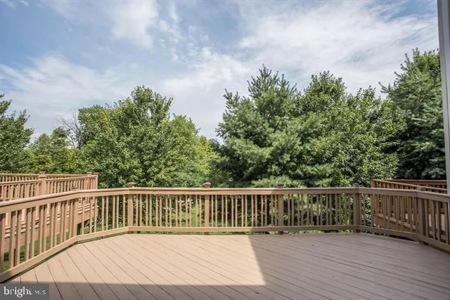 a balcony with wooden floor and fence