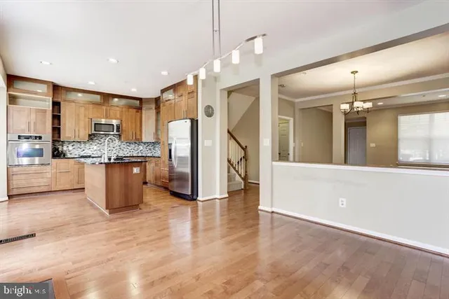 a view of kitchen with granite countertop stove top oven and cabinets