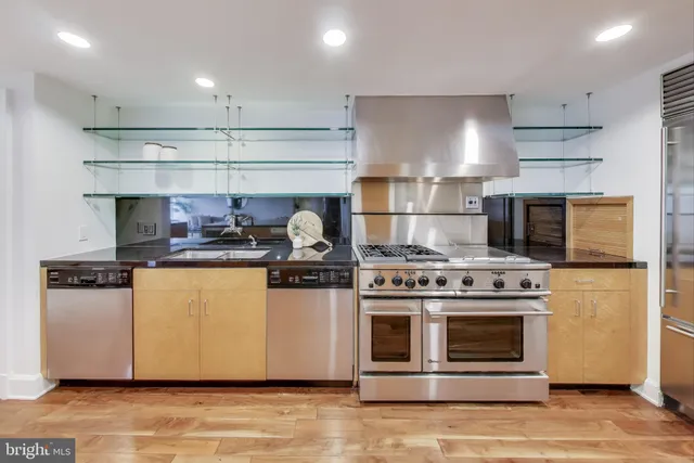 a kitchen with stainless steel appliances granite countertop a stove and a refrigerator