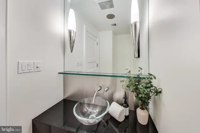 a spacious bedroom with a bed and a lamp