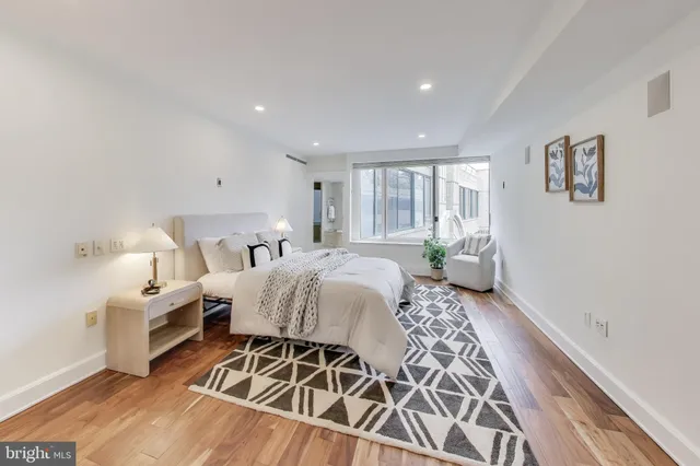 a bedroom with a bed and a table with chair