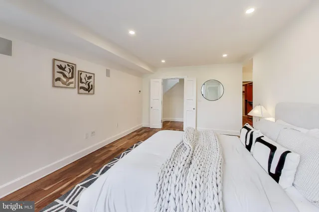 a spacious bathroom with a bathtub sink and mirror