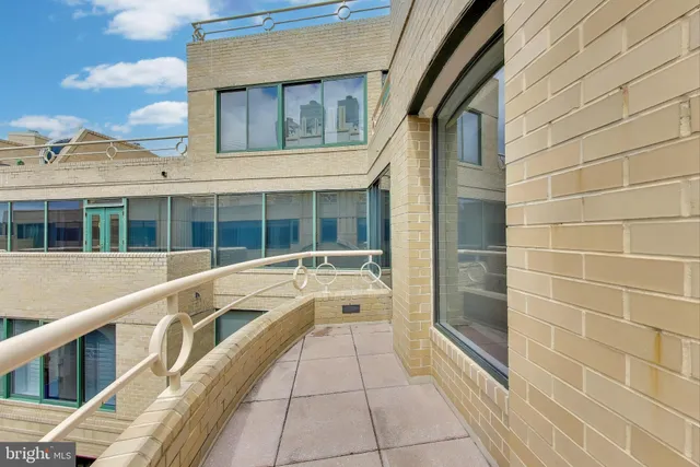 a living room with furniture and large windows