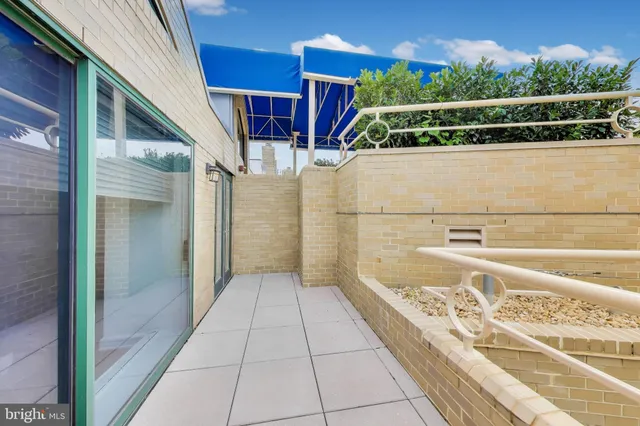 a view of a patio with swimming pool and a chairs
