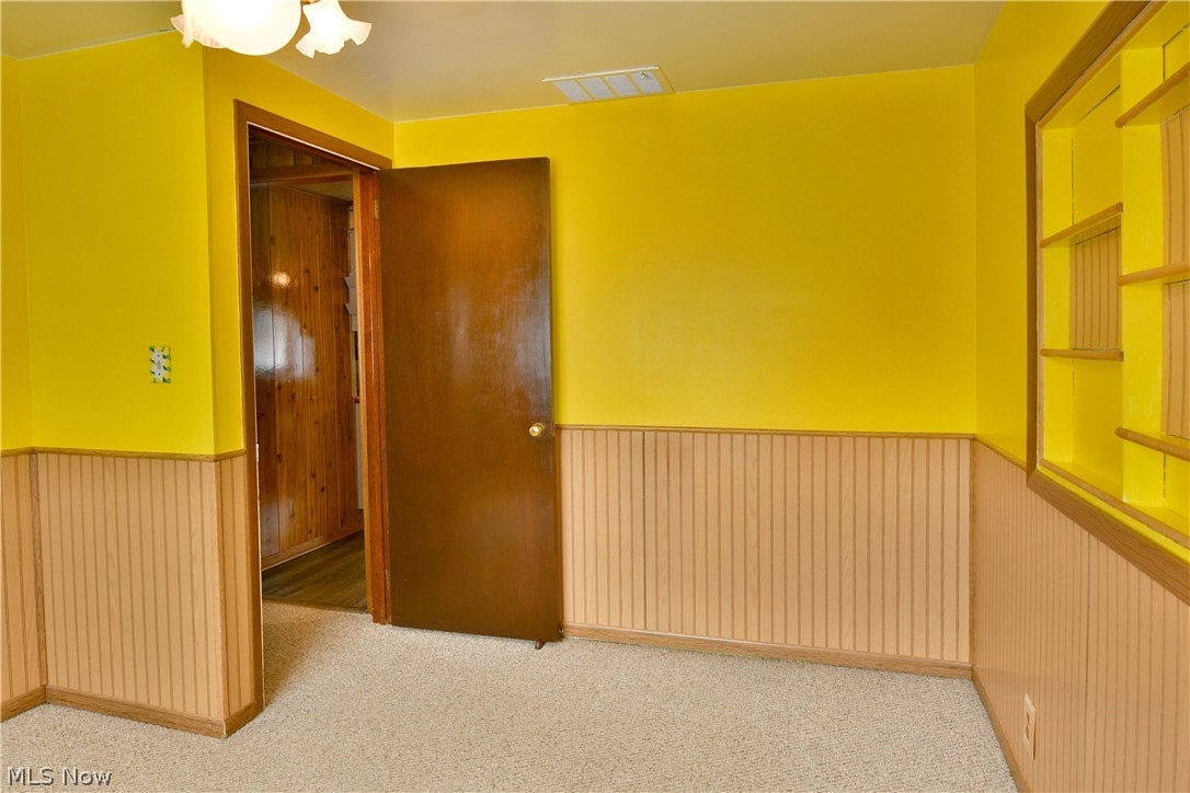 878 Ridge Road Vienna, OH 44473 - Photo 39 of 50 Unfurnished room featuring wainscoting and light carpet