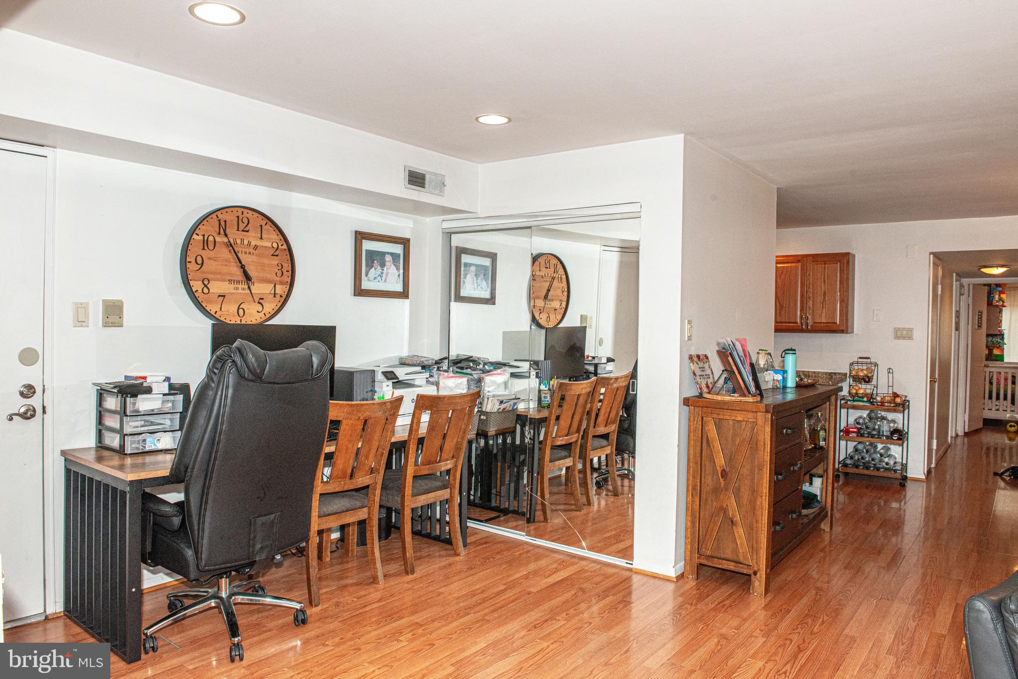 9908 Bustleton Avenue, Unit A8 Philadelphia, PA 19115 - Photo 11 of 24 a living room with furniture a wooden floor and a clock