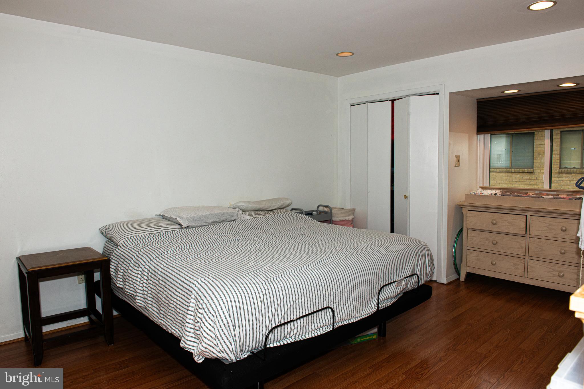 9908 Bustleton Avenue, Unit A8 Philadelphia, PA 19115 - Photo 17 of 24 a bedroom with a bed and a dresser
