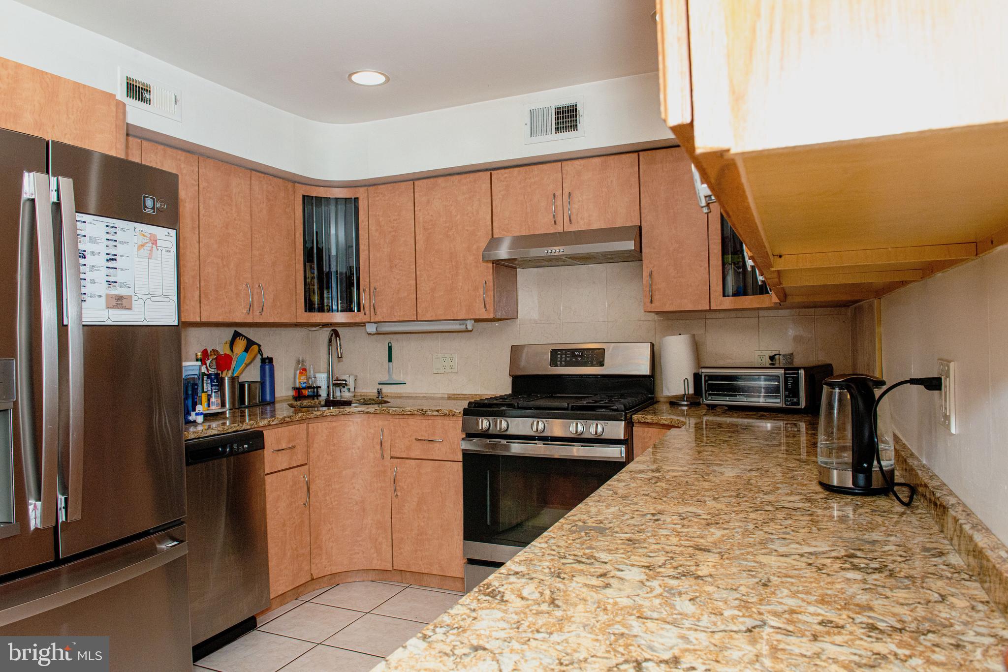 9908 Bustleton Avenue, Unit A8 Philadelphia, PA 19115 - Photo 2 of 24 a kitchen with stainless steel appliances granite countertop a refrigerator and a stove top oven