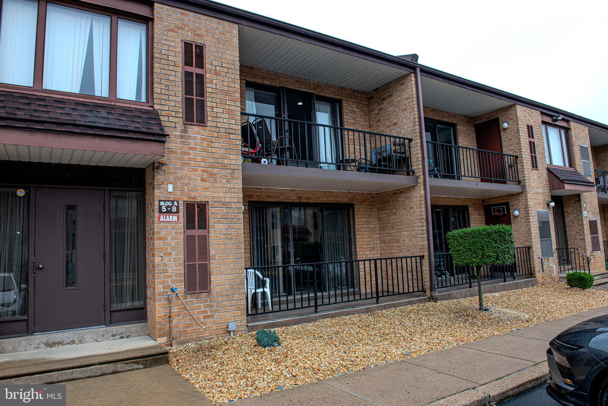 9908 Bustleton Avenue, Unit A8 Philadelphia, PA 19115 - Photo 24 of 24 a view of a building with a bench in front of building