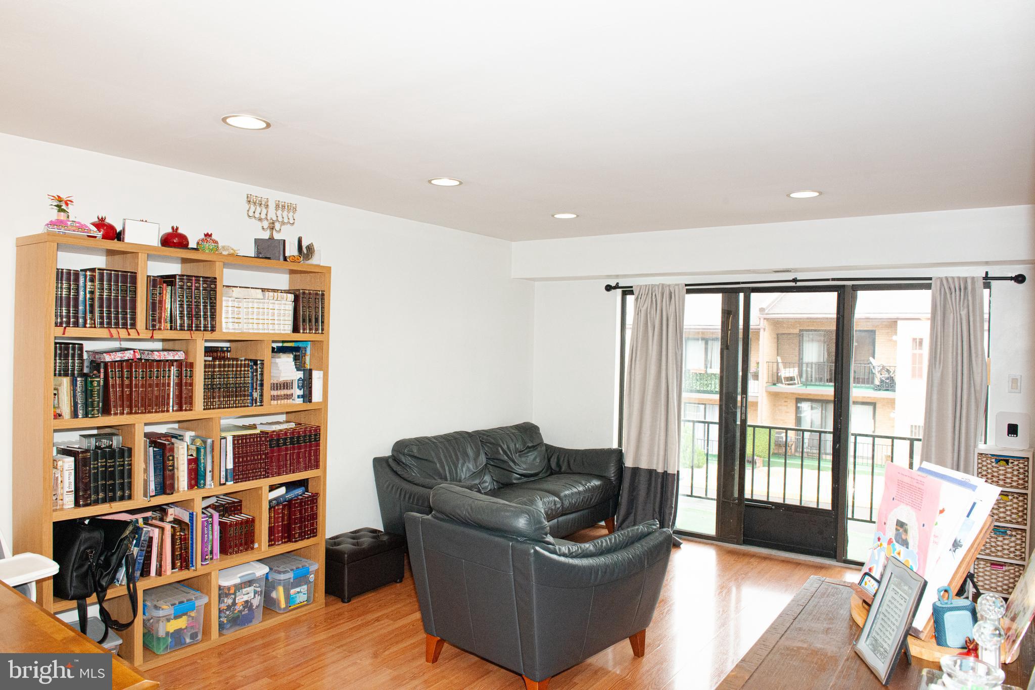 9908 Bustleton Avenue, Unit A8 Philadelphia, PA 19115 - Photo 8 of 24 a living room with furniture and a book shelf