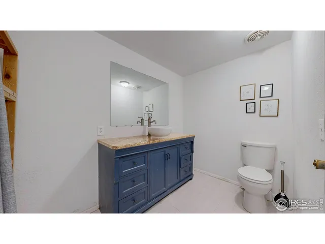 a living room with furniture and a baby crib