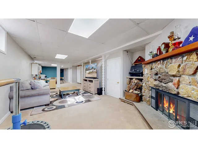 a living room with a bed furniture and a window