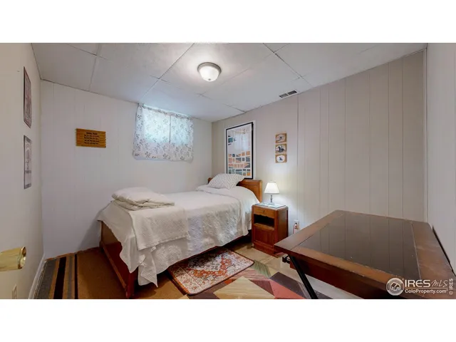 a living room with furniture and a baby crib