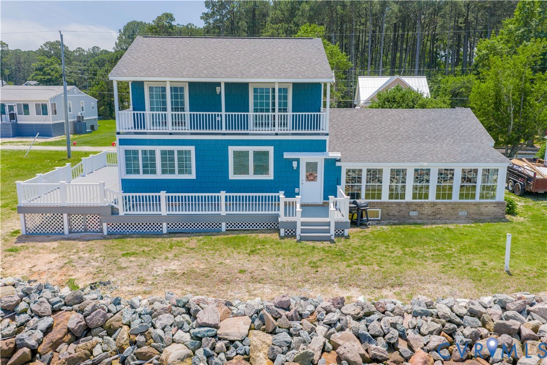 154 Riverside Drive Deltaville, VA 23043 - Photo 3 of 38 a view of a house with a yard patio and swimming pool