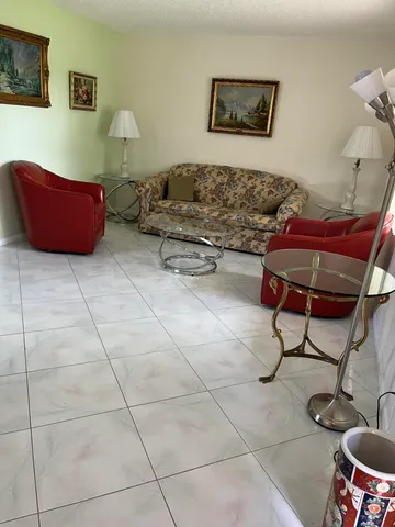 a living room with furniture and a rug