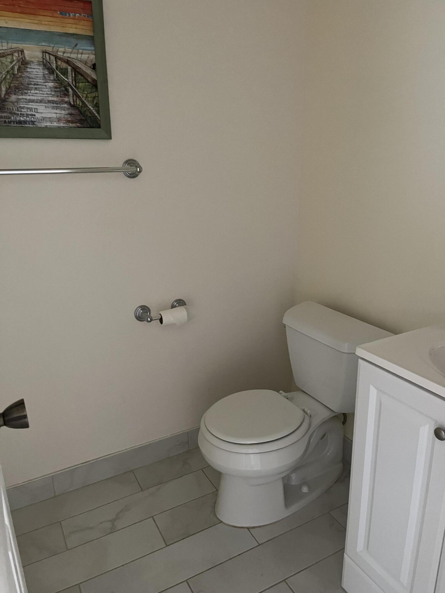457 Flanders I, Unit 457 Delray Beach, FL 33484 - Photo 9 of 13 a white toilet sitting next to a white wall