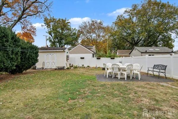 a view of a house with backyard and sitting area