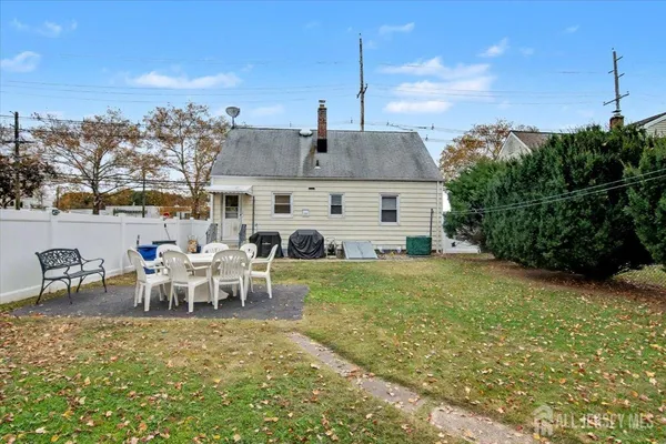 a view of a house with backyard porch and furniture