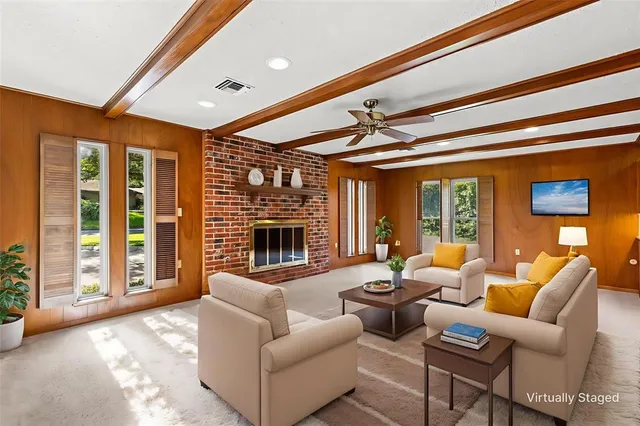 a living room with furniture and a fireplace