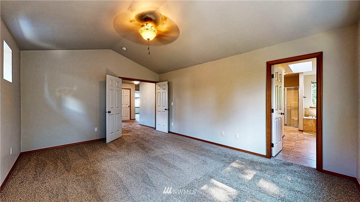 4524 147th Place Southeast Bothell, WA 98012 - Photo 18 of 33 an empty room with a chandelier fan and windows