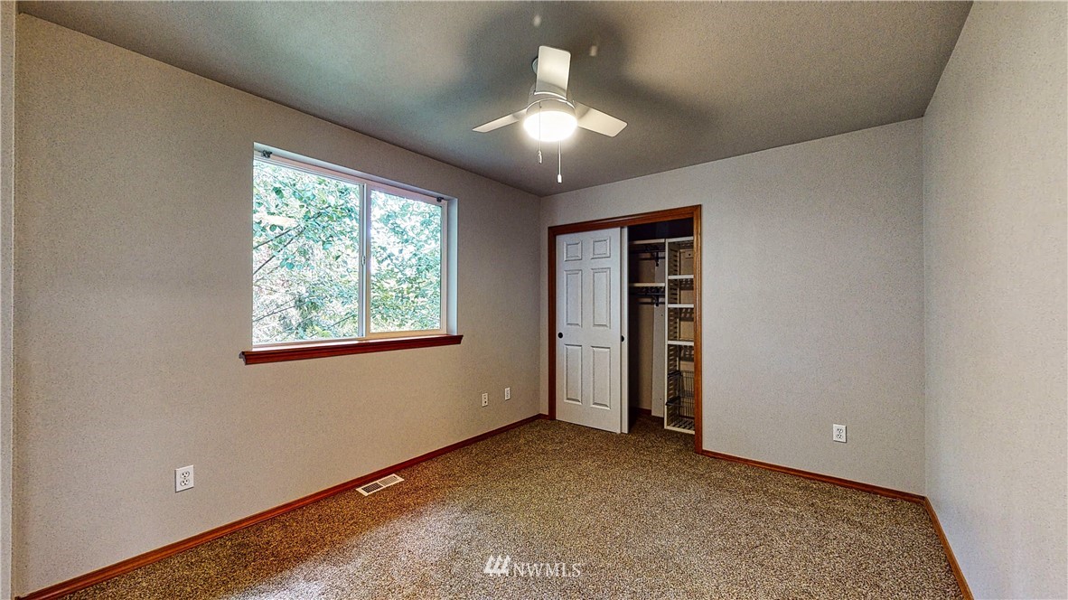 4524 147th Place Southeast Bothell, WA 98012 - Photo 27 of 33 an empty room with chandelier fan and windows