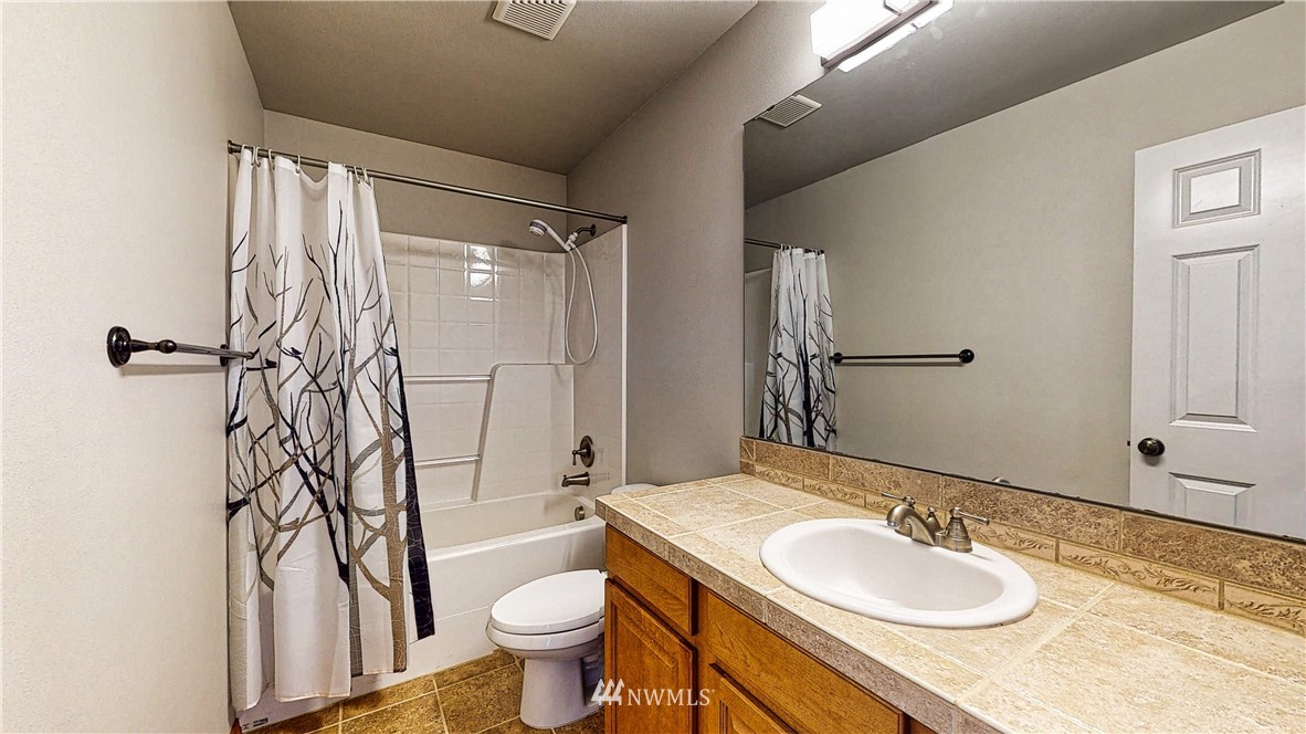 4524 147th Place Southeast Bothell, WA 98012 - Photo 28 of 33 a bathroom with a granite countertop sink toilet and shower