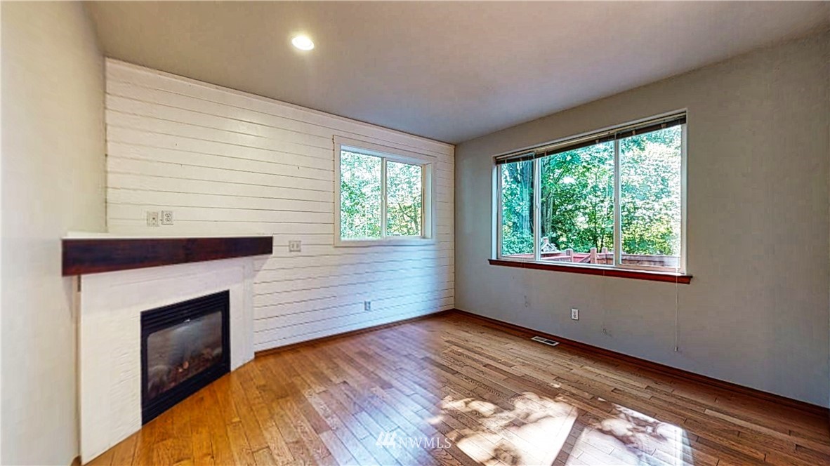 4524 147th Place Southeast Bothell, WA 98012 - Photo 10 of 33 a view of empty room with wooden floor and fireplace