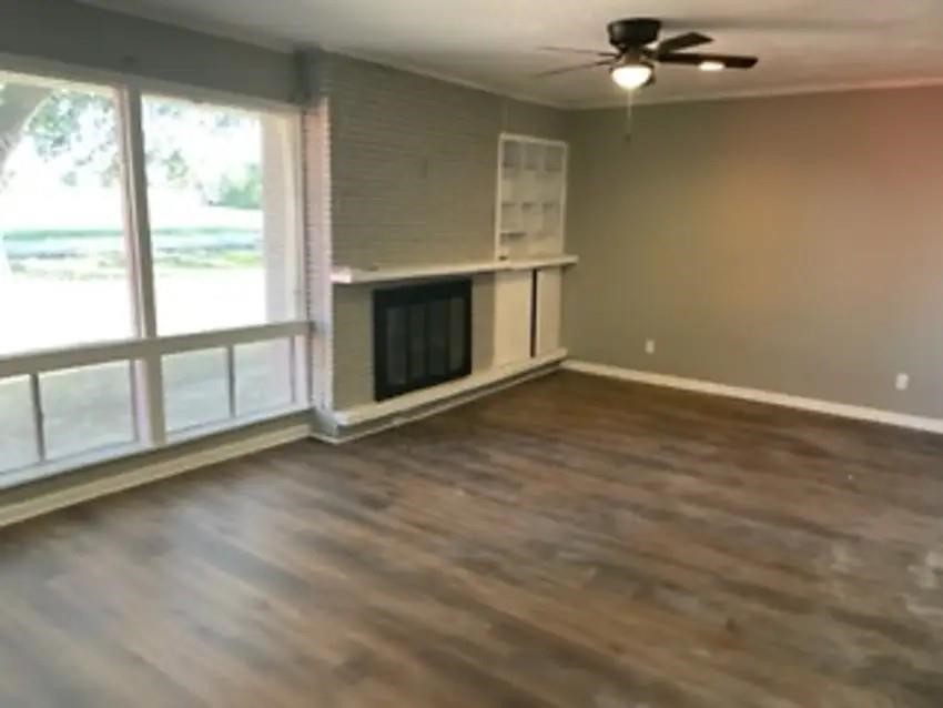 105 Dooley Street Prairie View, TX 77446 - Photo 2 of 8 an empty room with windows and fireplace