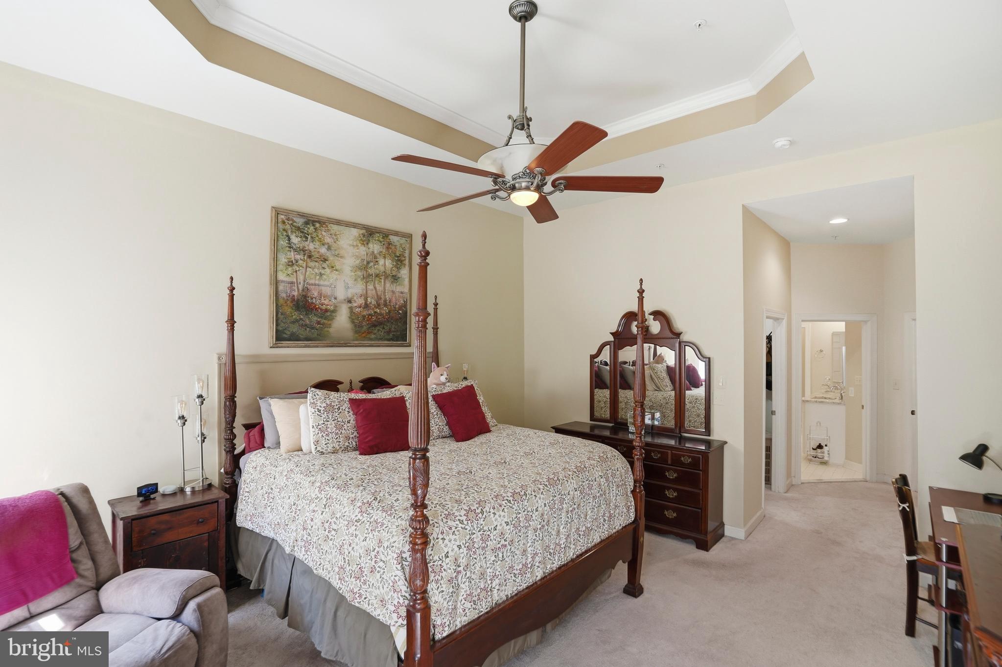 4109 Winterhazel Road, Unit 4109 Baltimore, MD 21208 - Photo 18 of 46 a bedroom with a bed and a chandelier