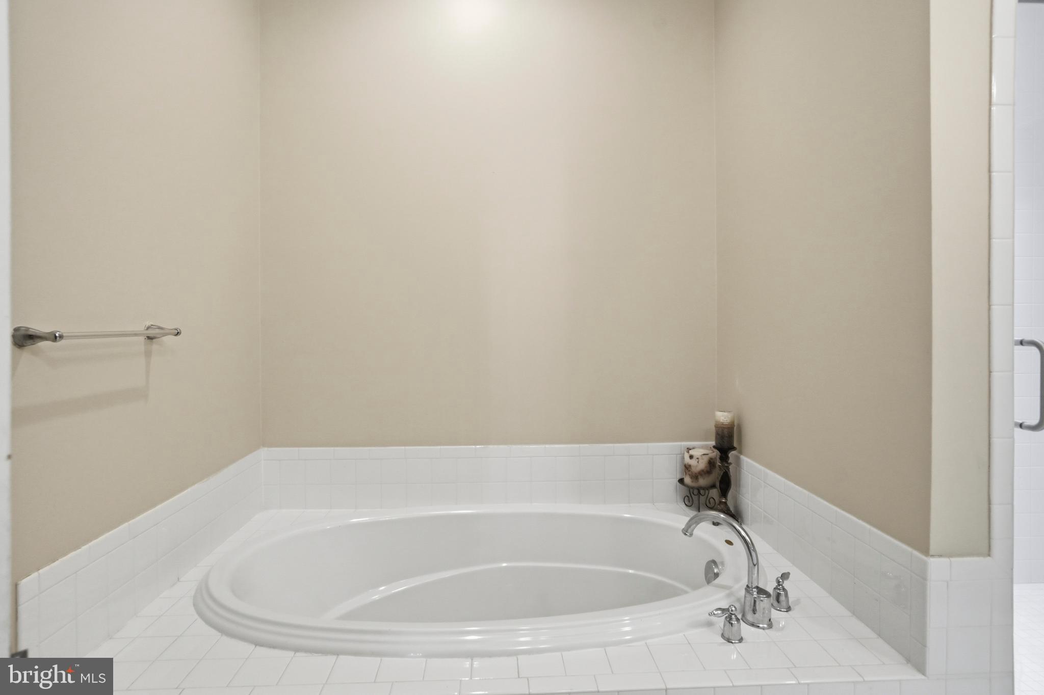4109 Winterhazel Road, Unit 4109 Baltimore, MD 21208 - Photo 22 of 46 a white bath tub sitting in a bathroom