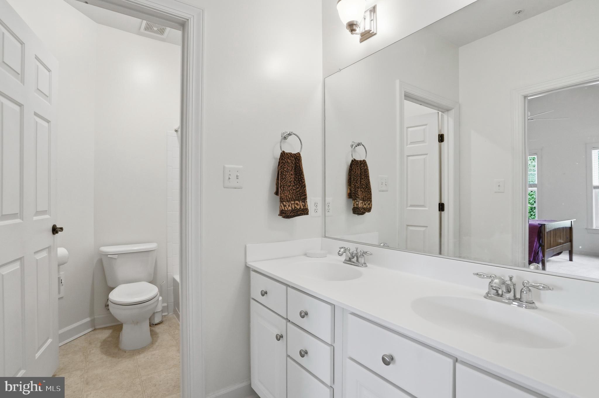 4109 Winterhazel Road, Unit 4109 Baltimore, MD 21208 - Photo 29 of 46 a bathroom with a double vanity sink and a toilet
