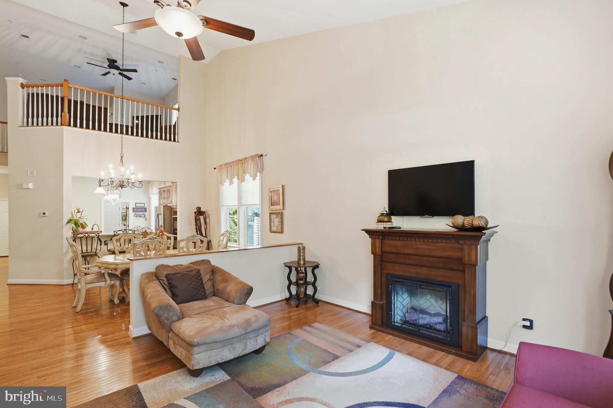 4109 Winterhazel Road, Unit 4109 Baltimore, MD 21208 - Photo 7 of 46 a living room with furniture a flat screen tv and a fireplace
