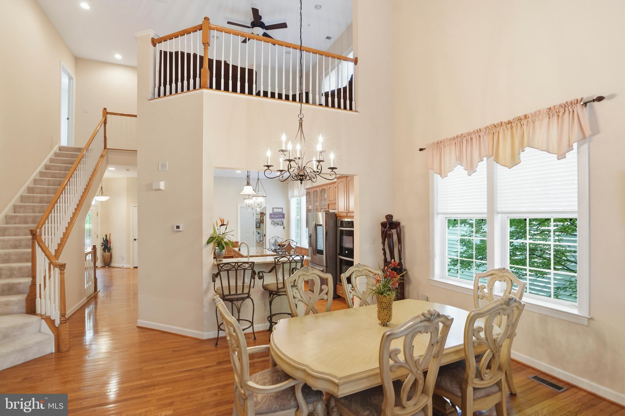 4109 Winterhazel Road, Unit 4109 Baltimore, MD 21208 - Photo 10 of 46 a view of a dining room with furniture window and wooden floor