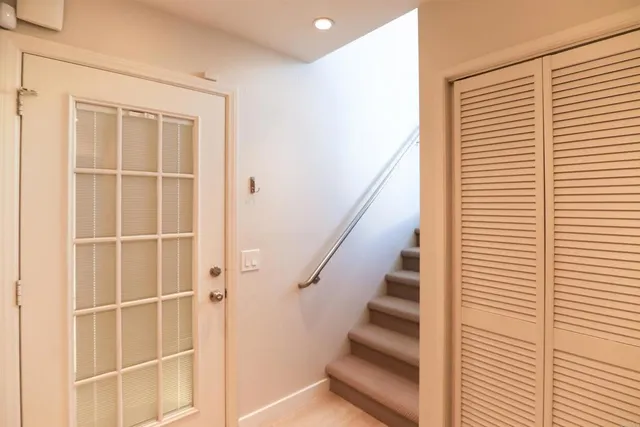 a view of entryway with wooden floor and stairs