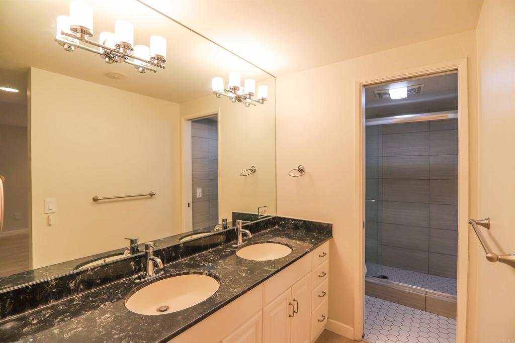 307 Shoemaker Lane Solana Beach, CA 92075 - Photo 18 of 31 a bathroom with a granite countertop sink and a mirror