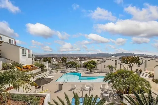 a view of a swimming pool with outdoor seating