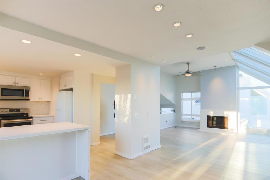 307 Shoemaker Lane Solana Beach, CA 92075 - Photo 4 of 31 a view of a kitchen with a sink and dishwasher a refrigerator with wooden floor